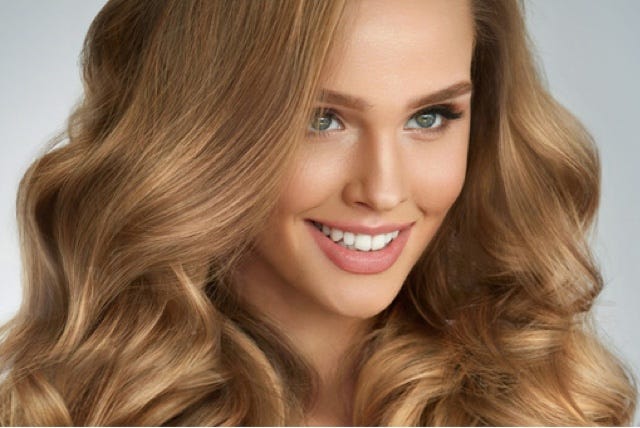 Woman smiling with great hair.